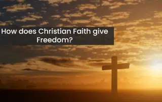 A cross standing in faith in a field in front of a sun set.